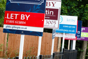 A row of estate agents for sale boards